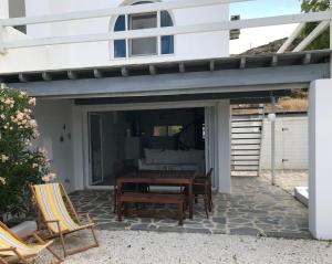 a patio with a wooden table and two chairs at Orkos House in Plaka