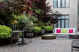 a patio with a couch and chairs and plants at Savona 18 Suites - Member of Preferred Hotels & Resorts in Milan