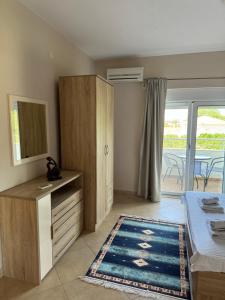 a living room with a cabinet and a rug at Sunrise house apartments in Ulcinj