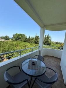 a table and chairs on a balcony with a view at Sunrise house apartments in Ulcinj