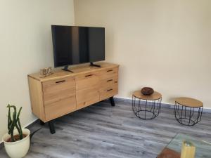 a television on a dresser in a room with two stools at Gemütliches Ferienhaus - PENTER in Habrachćicy