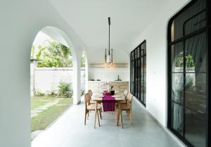 a dining room with a table and chairs at Pradnya Villa in Ubud