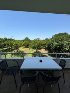 a table and chairs on a balcony with a view at Sunrise house apartments in Ulcinj