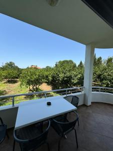 a white table and chairs on a balcony at Sunrise house apartments in Ulcinj