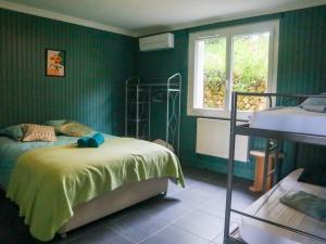 a green bedroom with a bed and a window at Le Bernicaille Gîte à la campagne in Saint-Cirice +29 photos