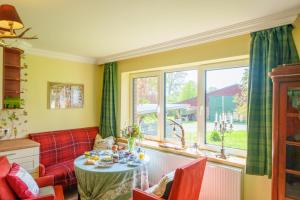 a living room with a red couch and a table at Fürst Pless in Gorleben
