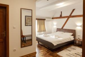 a bedroom with a bed and a mirror at Prenoćište Omega Luxury in Čačak +65 photos