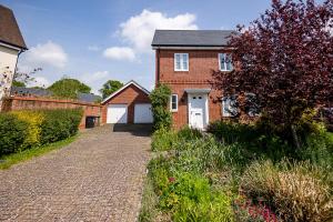 a brick house with a driveway in front of it at Spacious 4BD Home with Patio garden, BBQ & Parking in Timsbury