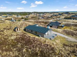 an aerial view of a small house in a field at Lovely Holiday Home With Outdoor Sauna - 1025 in Ringkøbing