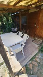 a white picnic table and chairs on a patio at Chalet chez l'habitant in Barbentane