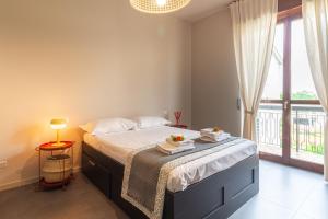 a bedroom with a bed and a large window at Urban House - 301 in Monza