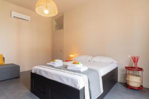 a bedroom with a bed with towels on it at Urban House - 301 in Monza +36 photos