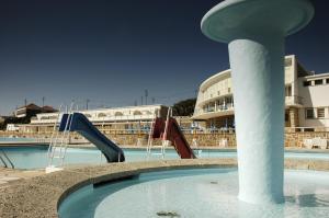 a pool of water with slides in a building at Sintra Sol - Apartamentos Turisticos in Sintra