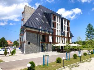 a building with umbrellas in front of it at Central green in Divčibare