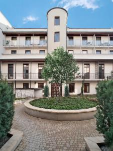 un edificio de apartamentos con un árbol delante de él en Parkside Apartments Old Town en Cracovia