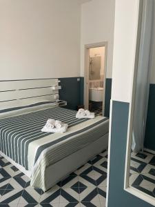 a bedroom with a bed with two towels on it at DONNA MARIA in Sapri