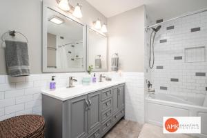 a bathroom with a sink and a tub and a mirror at 1 Happy Acre in Holland