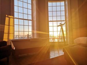 a room with a large window and a telescope at Drakes Hotel in Brighton & Hove