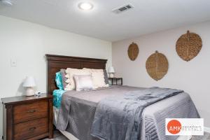 a bedroom with a bed and a wooden dresser at 1 Happy Acre in Holland