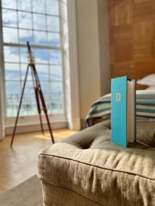 a book sitting on a couch in a living room at Drakes Hotel in Brighton & Hove