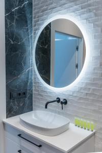 a bathroom with a white sink and a mirror at Kochanowskiego Luxury Apartment by BookingHost in Poznań +34 photos
