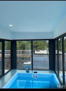 a large blue tub in a room with windows at BM Plaza in Bakuriani
