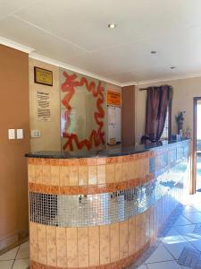 a lobby with a tile counter in a building at The green room in Phalaborwa +2 photos
