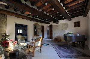 uma sala de estar com uma mesa e um piano em Tenuta dei Cavalieri em Molino del Piano