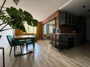 a kitchen and dining room with a table and chairs at MISVEST Lord Karol in Zabrze