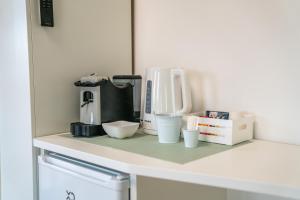 a counter with a coffee maker and other items on it at Vento del Conero in Sirolo