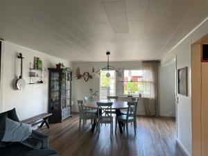 a dining room and living room with a table and chairs at Familjevänligt hus i Kiruna in Kiruna +5 photos