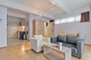 a living room with a couch and a table at Ambassador Suites Leuven in Leuven