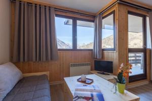 a room with a desk with a computer and some windows at Les Mélèzes in Saint-Chaffrey +45 photos