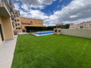 a large backyard with a pool and grass at Navarrete Txiki in Navarrete
