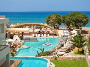a view of a swimming pool at a resort at Enorme Teatro Beach - Adults Only in Amoudara Herakliou