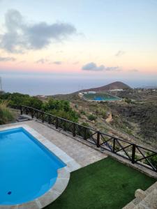a villa with a pool and a view at Casa Rural Achacay in Fasnia