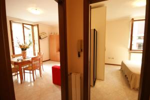 a room with a table and a room with a bedroom at Peter Schubert in Baveno