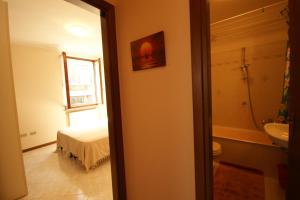 a bedroom with a bed and a bathroom with a sink at Peter Schubert in Baveno +11 photos