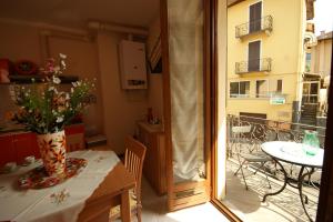 a room with a table with a vase of flowers on a balcony at Peter Schubert in Baveno