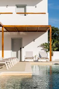 a villa with a swimming pool and a resort at Aspronissos Hotel in Skiathos
