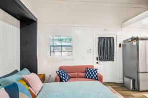 a room with a bed and a refrigerator in it at Spacious Resort with 2 Cabins on 3 Acres in Driftwood