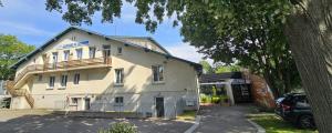a white building with a balcony on the side of it at Auberge de Jeunesse de Mulhouse in Mulhouse