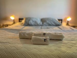 two towels sitting on top of a bed at À Beira Lago - Casa de férias in Mira +93 photos