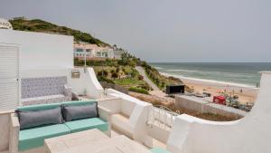 a view of the beach from the balcony of a house at Casas da Praia by Sevencollection in Salema