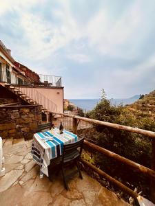 a table on a balcony with a view of the ocean at Cinque Terre, Sea View Home in Manarola