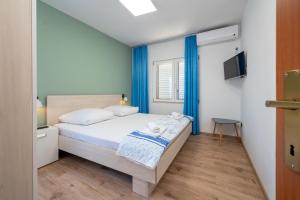 Ένα ή περισσότερα κρεβάτια σε δωμάτιο στο Apartments Zdravko