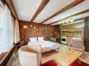 a bedroom with a bed and a desk and a chair at Cimerose 1 in Verbier +5 photos