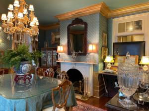 a dining room with a table and a fireplace at 22 Charlotte in Charleston