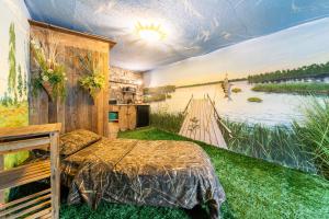 a bedroom with a bed and a painting of a river at City Center Garden Camping in Tallinn
