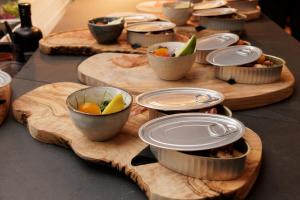 a table with bowls of food on wooden cutting boards at Vale Do Lobo Resort in Vale do Lobo